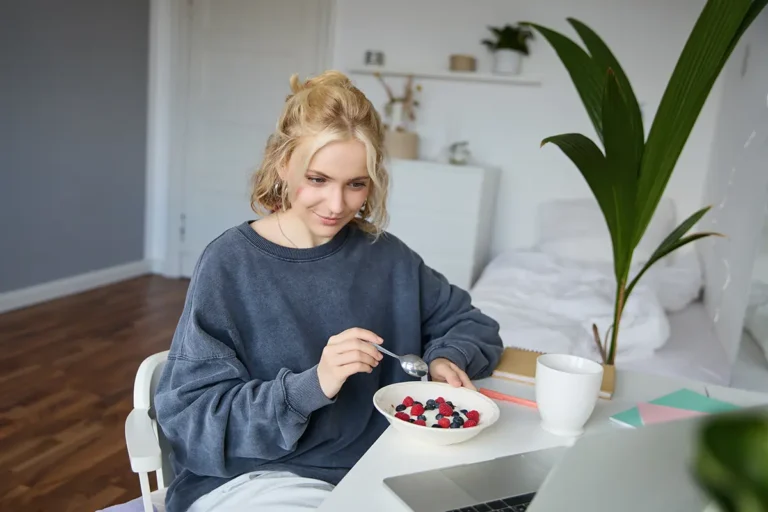 Girl watching videos on a lap and eating, GLP-1 Medications for Weight Loss, Do's & Don'ts
