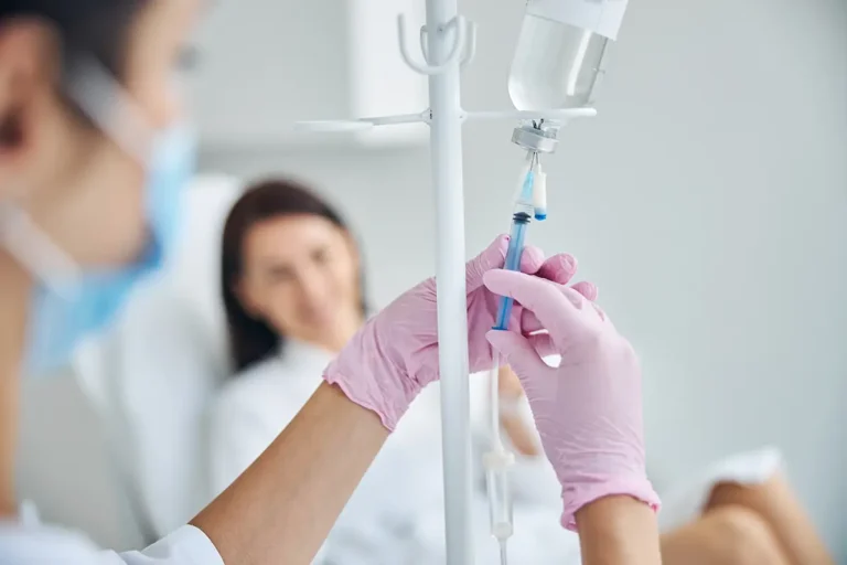 Healthcare worker preparing female patient for intravenous vitamin therapy, The Benefits of IV Therapy During the Cold Months