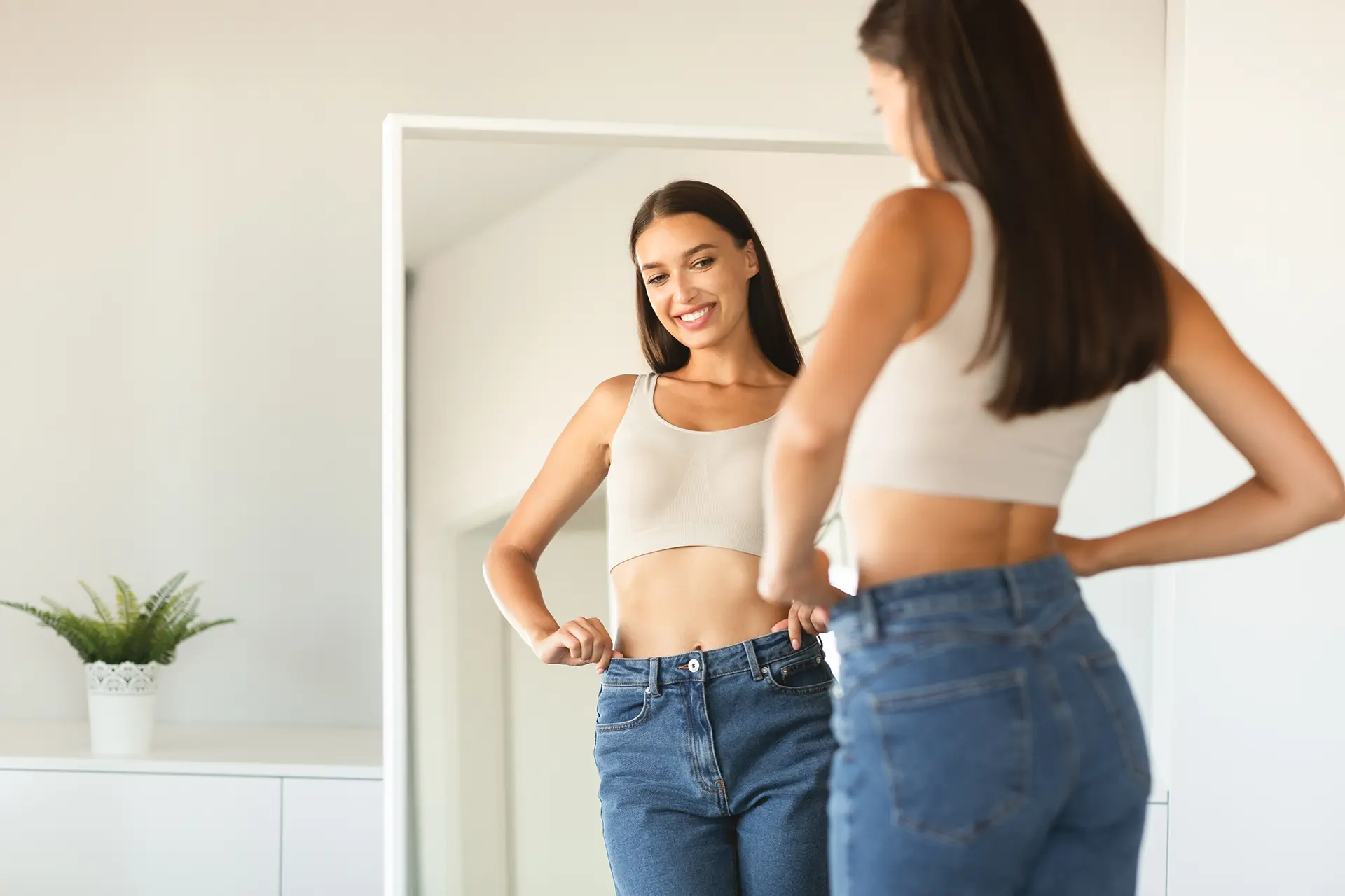 Semaglutide for Weight Loss, Smiling woman looking at the mirror